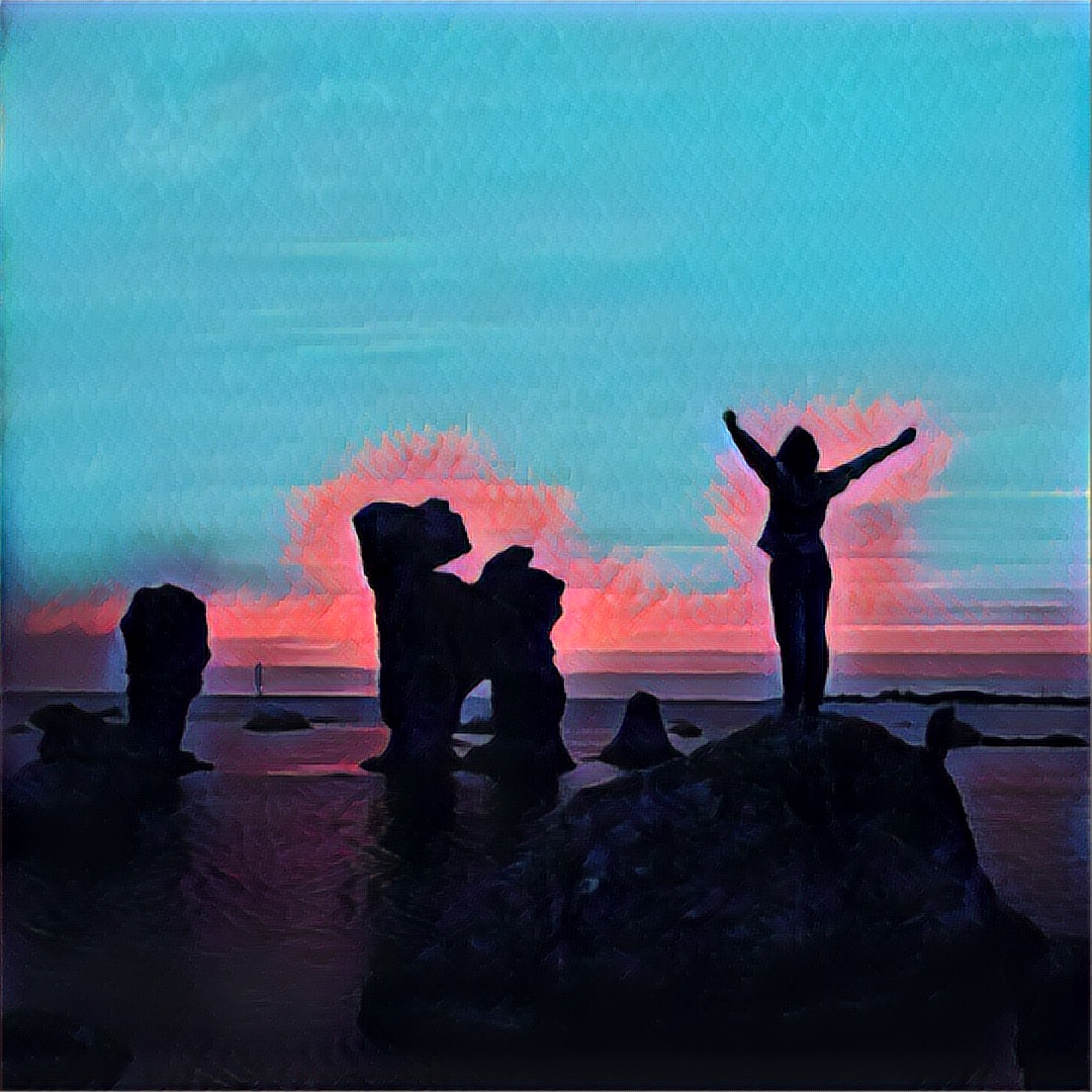 image of person on rock waking up with sunrise